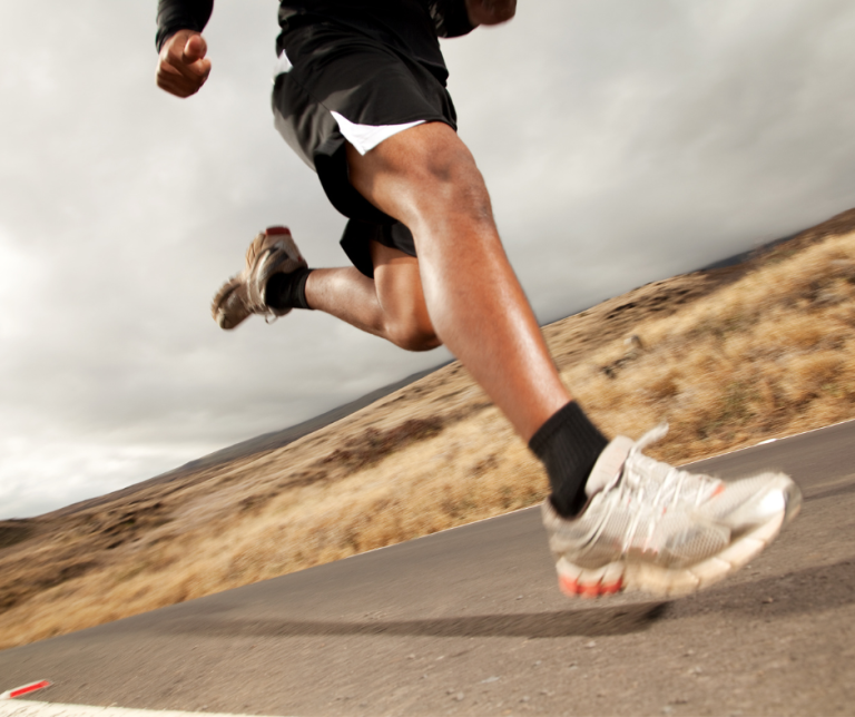 person running on the road working out Proper Running Form Pointers